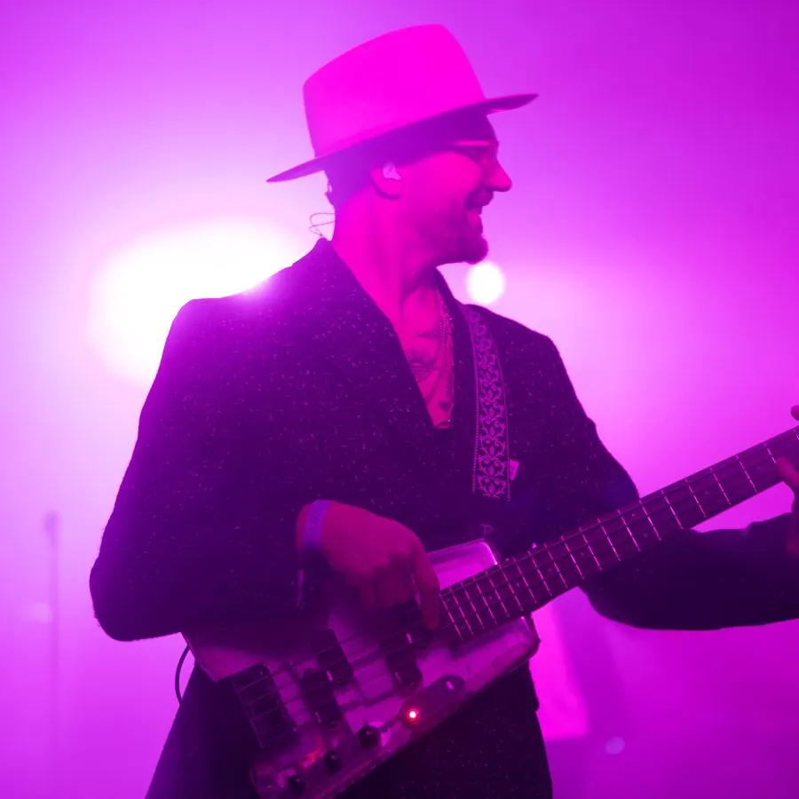Bassist on stage in pink light
